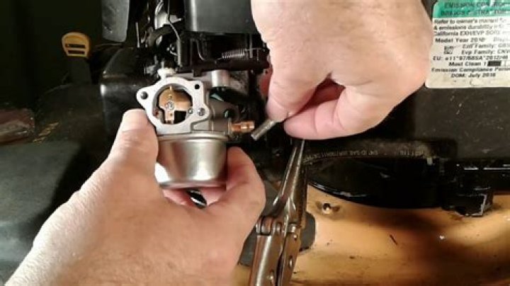 How do you remove a carburetor from a Briggs and Stratton lawn mower?